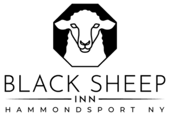 A simple, black outline of a sheep sitting.